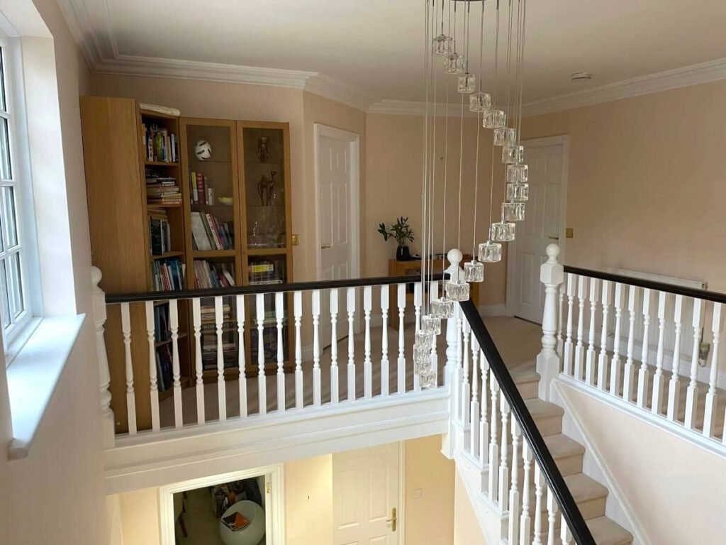 landing beige painted walls bookshelf chandelier cardiff primrose decor