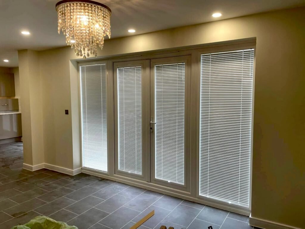 living room cream painted walls bifold doors chandelier cardiff primrose decor